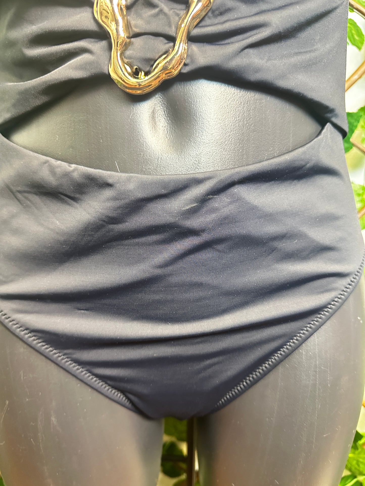 One-piece swimsuit with golden circle detail
