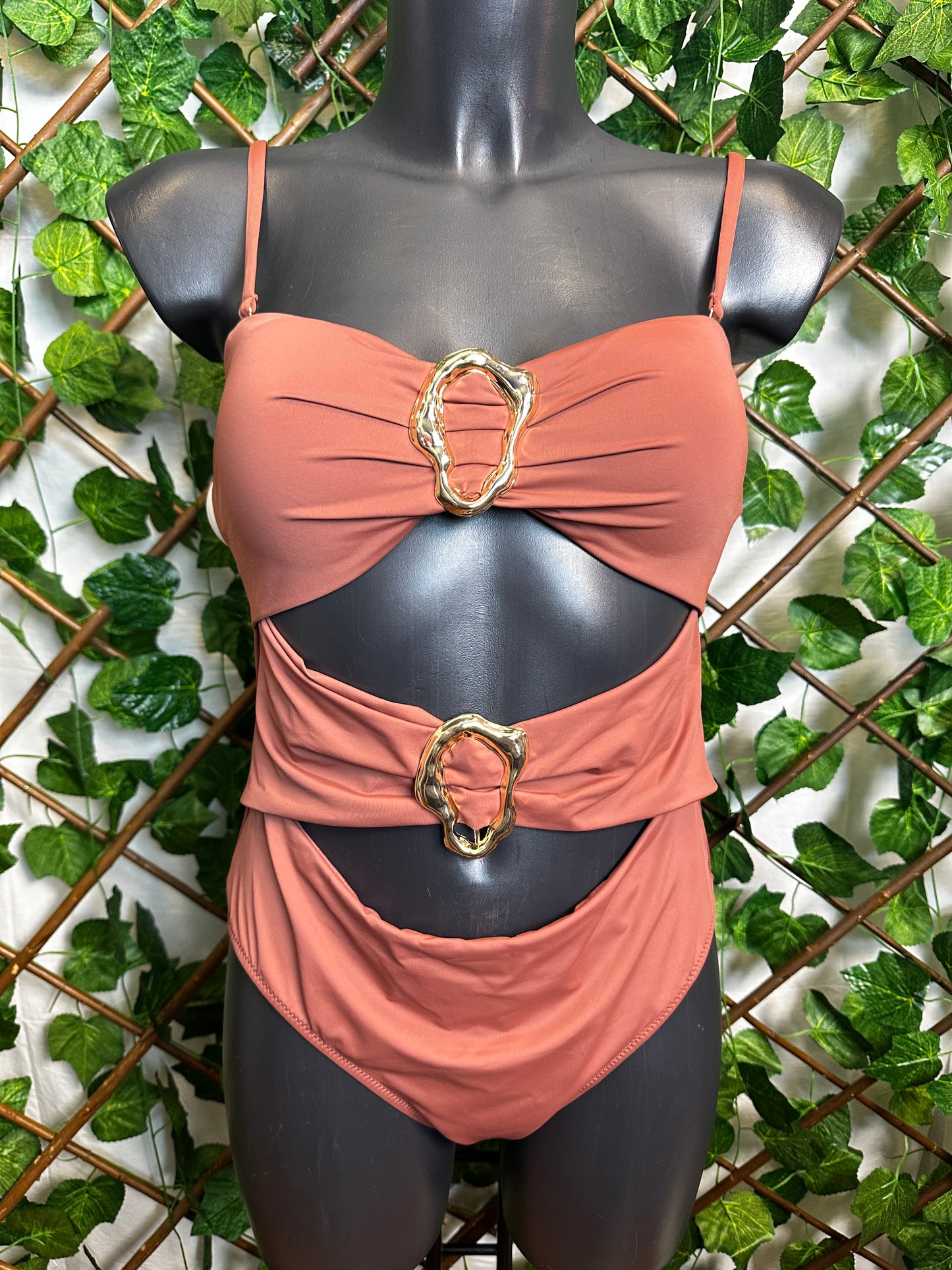 One-piece swimsuit with golden circle detail